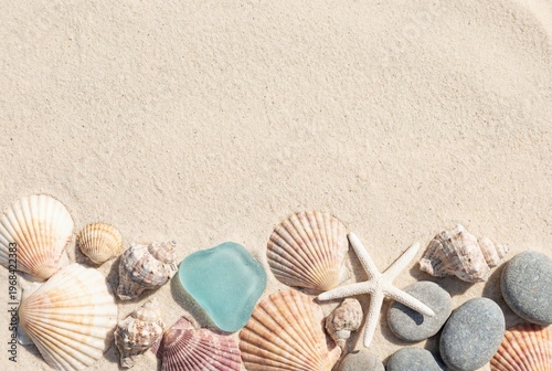 A relaxing summer vacation background featuring beautiful seashells a white starfish pebbles and blue sea glass on smooth beach sand with empty copy space for travel text.