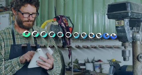 Bearded machinist tapping tablet in machine shop, animating progress UI filling and tracking output