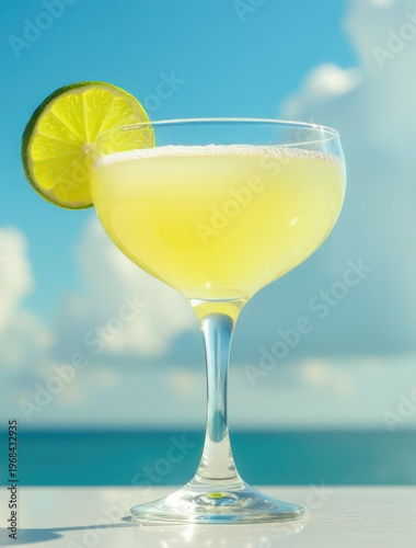 A glass filled with a drink sits on a table, perfect for a cozy evening or outdoor gathering