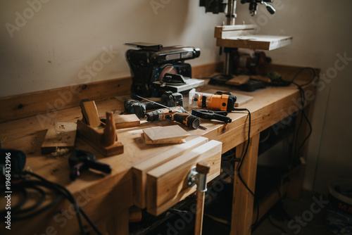 Φωτογραφία Woodworking workbench filled with power tools, hand tools and wood pieces