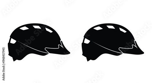 Two black mountain biking helmets displayed in a stark silhouette