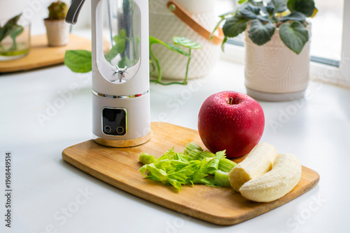 Green detox smoothie in the making. Apple, banana, celery, and a blender.