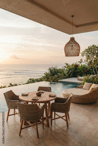 Luxury Patio Dining Area With Infinity Pool Overlooking Ocean At Sunset