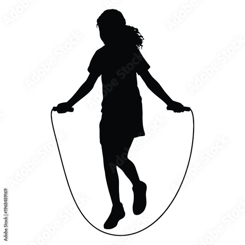 A young girl joyfully jumps rope in a dynamic pose presented as a striking silhouette