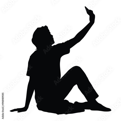 A person is seated and taking a self portrait with their mobile phone silhouette