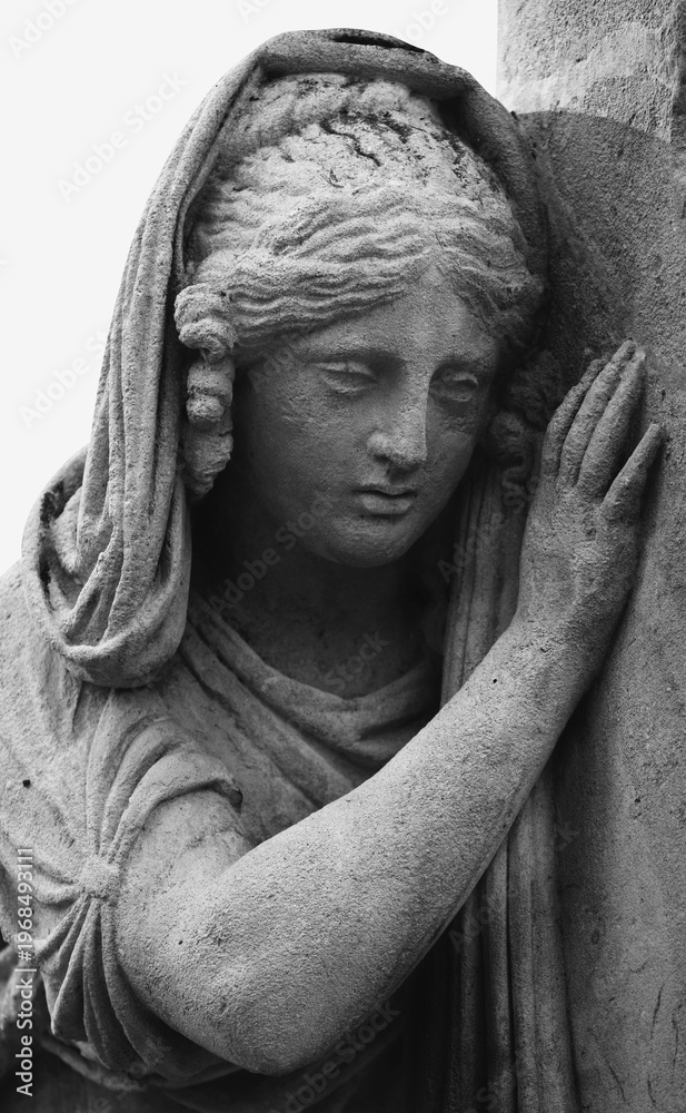 Fototapeta premium Female angel statue leaning on stone, symbolizing grief, tenderness, and quiet emotional farewell in a soft and compassionate composition.