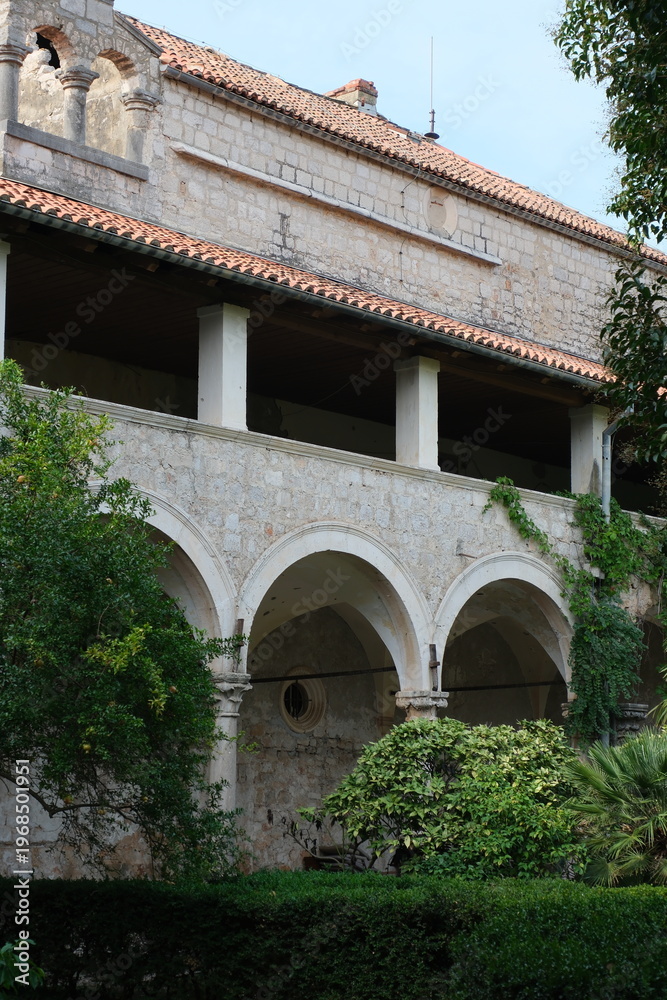 Fototapeta premium Arched stone architecture with ivy in a garden on the Lokrum Island, Croatia