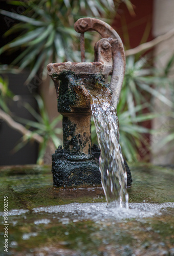 Old water pump repurposed to decorate an indoor fountain