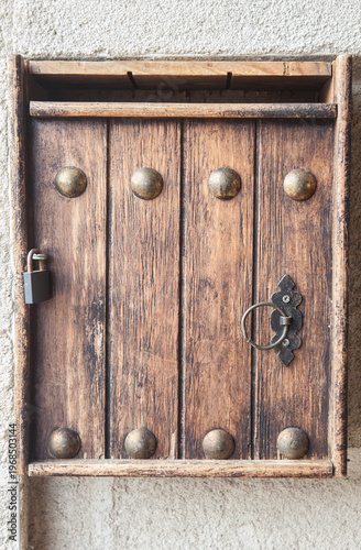 Wooden mailbox placed on the inner jamb of the door of a rural house