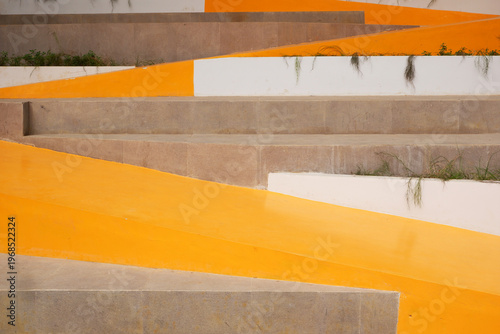 Canvas Print modern concrete stairways paired with a vibrant yellow-orange pathway create a bold, artistic contrast