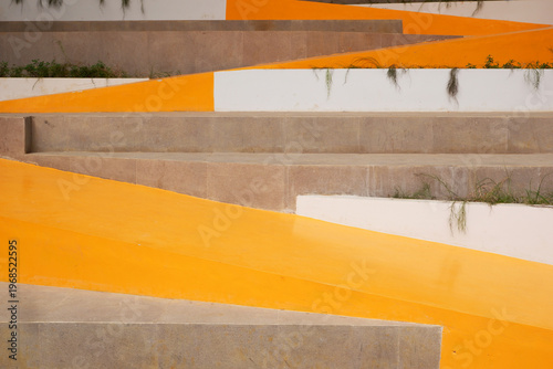 Fotografie modern concrete stairways paired with a vibrant yellow-orange pathway create a bold, artistic contrast