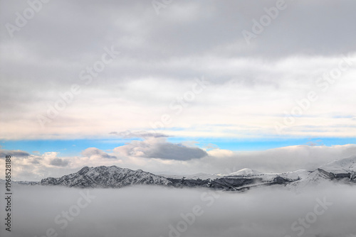 Mountains and clouds of Como lake after snowstorm, Lombardy winter landscape, Italy