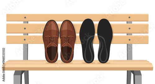 A pair of brown leather dress shoes rests beside black shoe insoles on a light brown park bench.