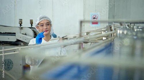 The production supervisor is inspecting and controlling the operation of packaging line of the canned fish processing plant