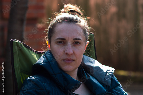 Young girl drinking coffee in the backyard on a sunny spring day