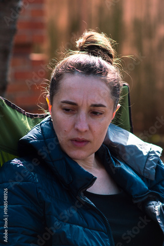 Young girl drinking coffee in the backyard on a sunny spring day