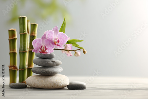 Orchids and stones arranged in a simple design on a wooden table