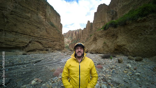Adventurer in Yellow Jacket Standing in the Majestic Palca Canyon, La Paz, Bolivia