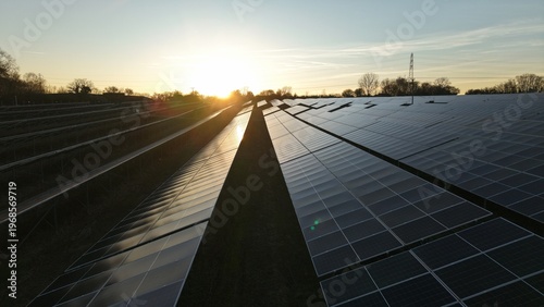 Photos Sunset aerial view of solar panels near Ipswich UK with golden light glinting of