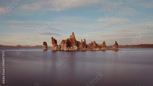 Minimalist Rock Formation in Calm Water with Cinematic Film Tones