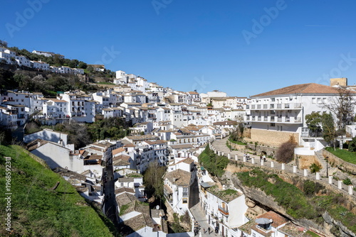 Exploring Setenil de las Bodegas, a unique village in Spain built into the rocks and hills under a clear blue sky