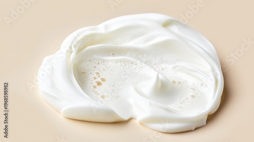 Organic Skin Cream Spread with Foam Bubbles on Beige Surface