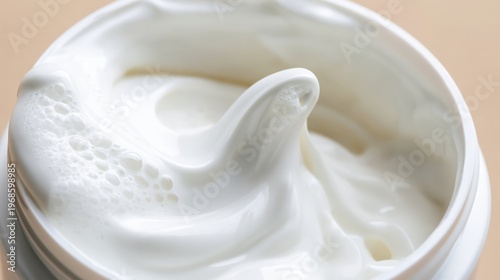 Close-Up Cream Swirl in Open Skincare Jar Beige Background