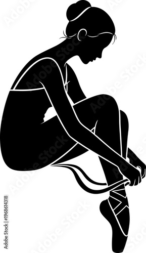 Silhouette of a ballerina tying her pointe shoes before a performance.