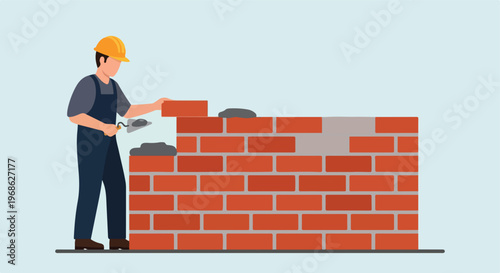 A construction worker wearing a hard hat building a wall with bricks and mortar