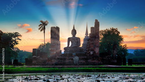 Silhouette Big Buddha at sunset in Wat Mahathat temple, Sukhothai Historical Park, Thailand.