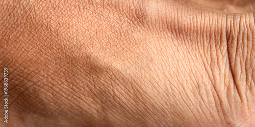 Detailed texture of men's feet, showing natural lines, fine wrinkles and epidermis structure in depth