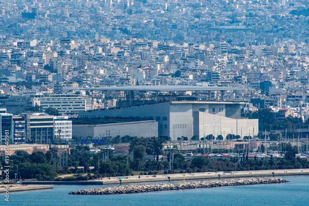 Obraz premium A cityscape view of Athens as seen from Piraeus over the Saronic Gulf in Greece.