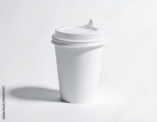 A plain white paper coffee cup with a lid, casting a subtle shadow on a white background, perfect for branding or design mockups