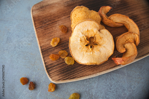 Dried Apple Slices and Raisins on a Wooden Board
