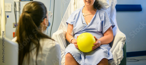 Female patient with physiotherapy person doing some rehabilitation in professional clinic.