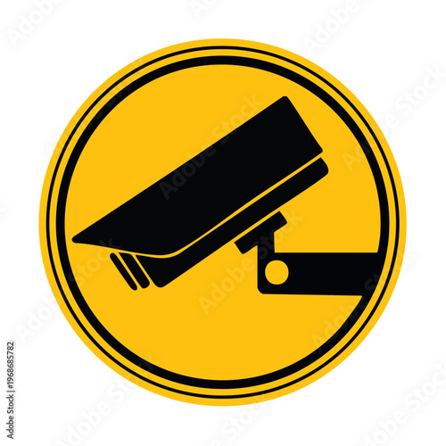Security camera in yellow sign.