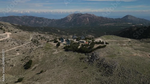 Satellite dish array on a remote, rocky mountaintop.