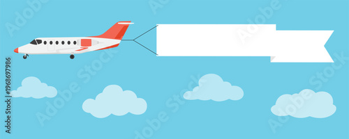 Fotografie Private jet airplane flying in blue sky with clouds and pulling a blank white ribbon banner for promotional text