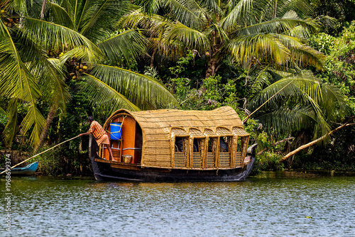 Boat tour at a Canal in the Lagoons and Backwater at the Coast near the city of Kochi or Cochin in the Province Kerala in India.