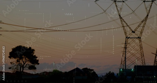 Showing transmission tower and power lines crossing dusk sky over rooftops tree, binary overlay