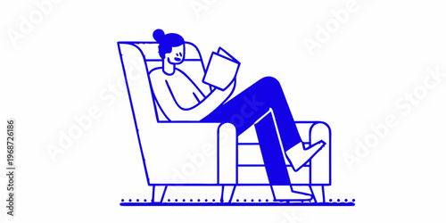Woman relaxing in a comfortable armchair engrossed in reading a book
