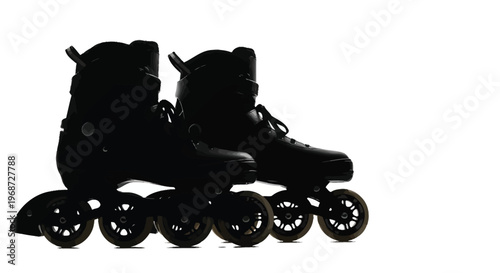 A pair of inline skates shown against a bright background silhouette