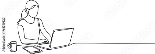 Woman sitting on couch using silver laptop and drinking from glass