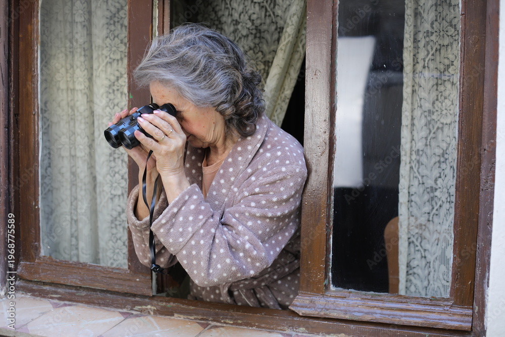 Naklejka premium A woman spying on her neighbours