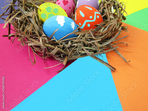    Happy Easter! Modern painted eggs inside the nest.                            
