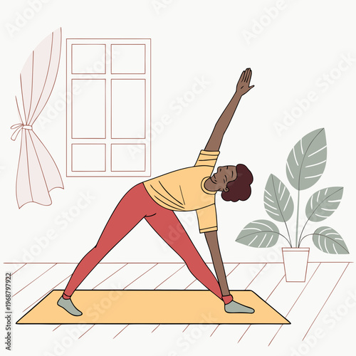 Woman in triangle pose on yoga mat in living room