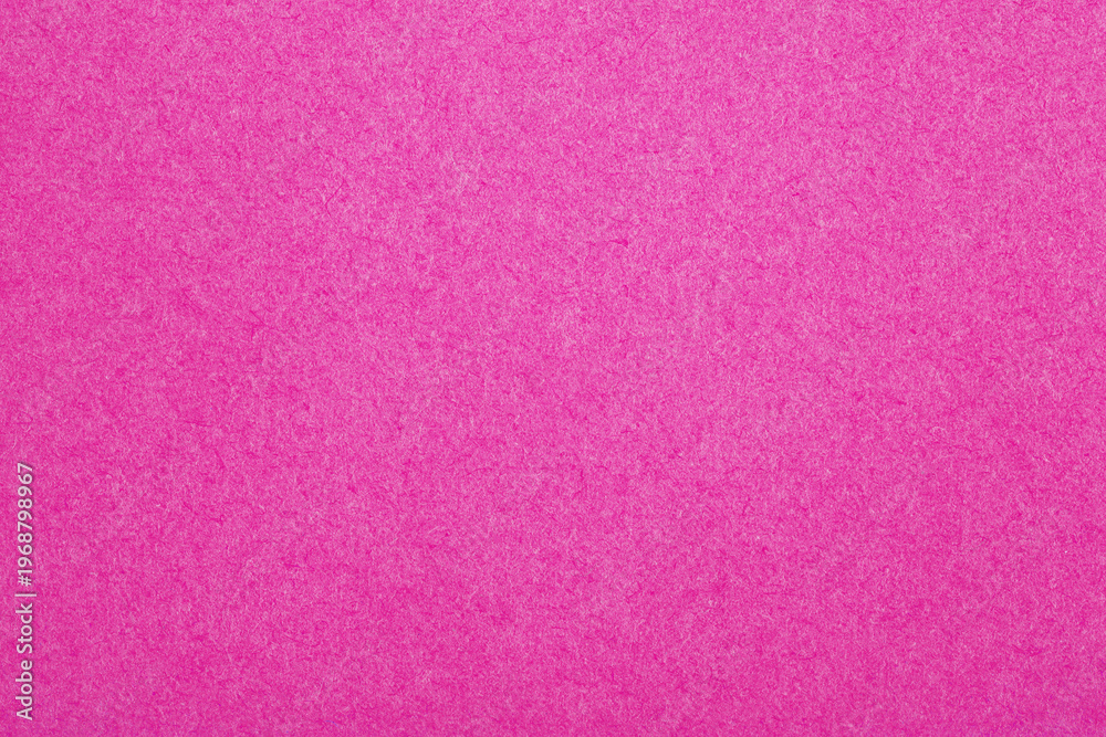 Fototapeta premium Vibrant pink textured paper background, perfect for creative designs, digital backdrops, and branding projects.