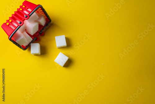 Sugar cubes and shopping cart concept