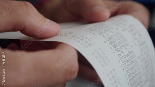Inflation Economy. Close-up Receipt Person Hands of Shopper Reading Accounting Report After Buying or Purchase Credit. Till Slip Man Holding Finance Document After Buying or Shopping in Supermarket.