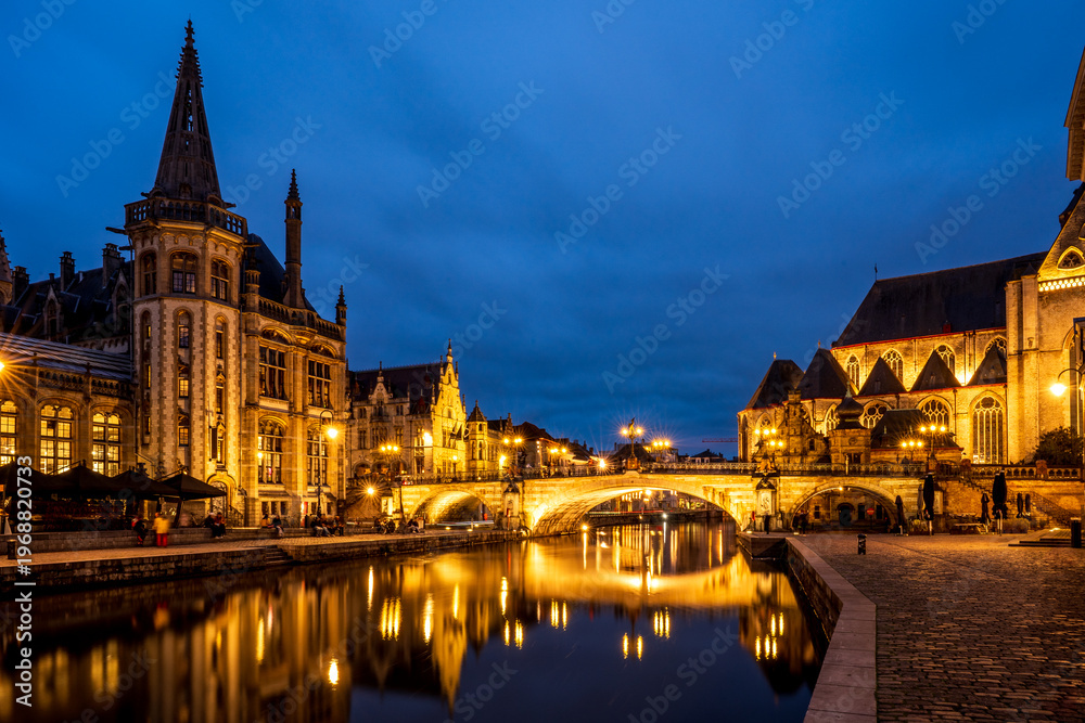 Fototapeta premium Night view of Ghent with Saint Michael's Bridge and the old post office, Belgium.